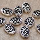 Mellandel, ornamenterad oval, antiksilver